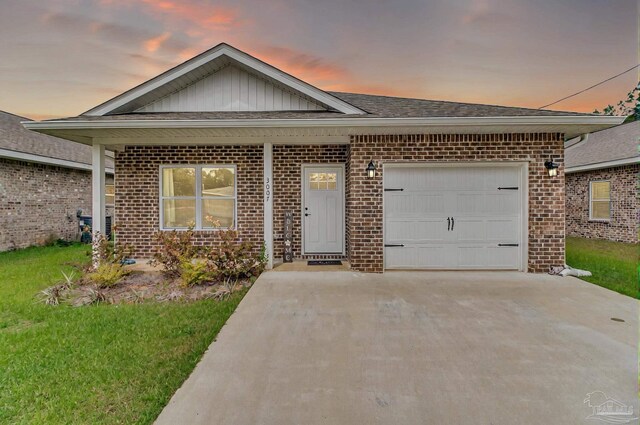 view of front of home featuring brick siding, concrete driveway, board and batten siding, an attached garage, and roof with shingles