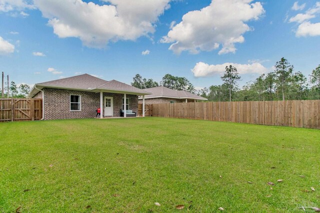 back of house featuring a patio and brick siding