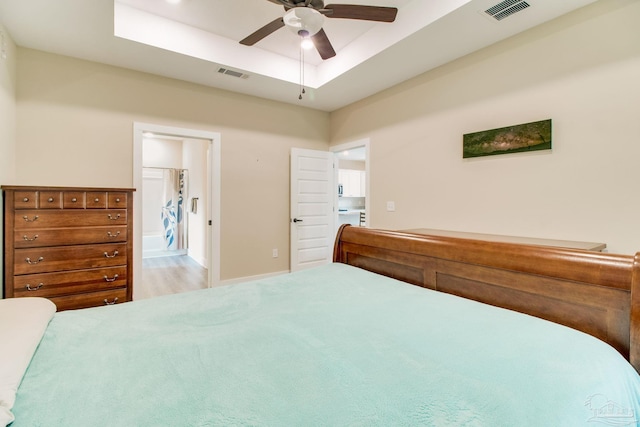 bedroom featuring a tray ceiling and a ceiling fan