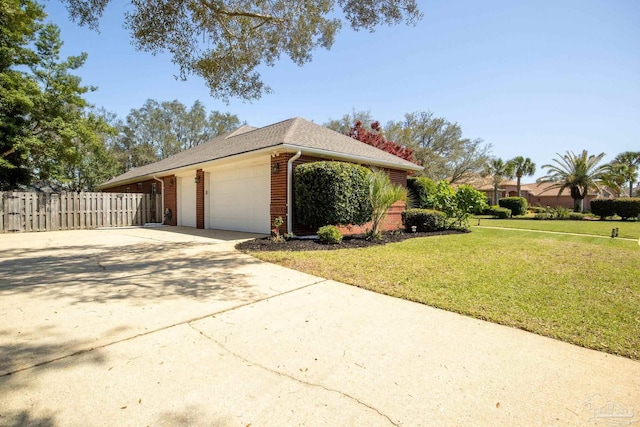 1126 Mary Kate Dr, Gulf Breeze, FL 32563 - view of property exterior featuring driveway, fence, a yard, a garage, and brick siding