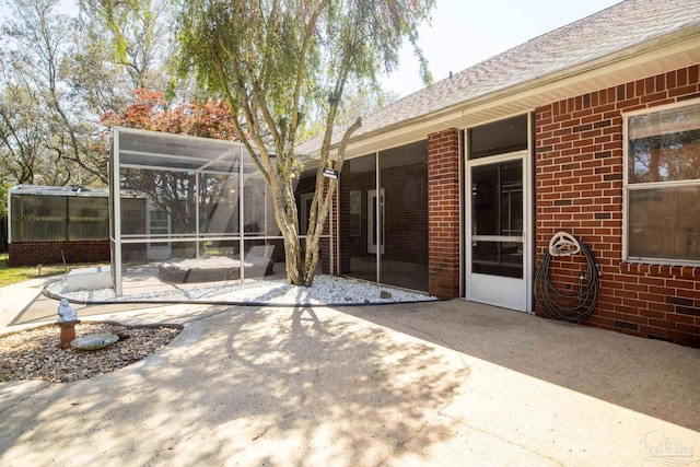 1126 Mary Kate Dr, Gulf Breeze, FL 32563 - back of house featuring glass enclosure, brick siding, roof with shingles, and a patio