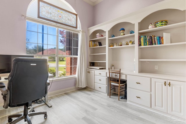 1126 Mary Kate Dr, Gulf Breeze, FL 32563 - office area featuring light wood-type flooring, baseboards, built in desk, and ornamental molding