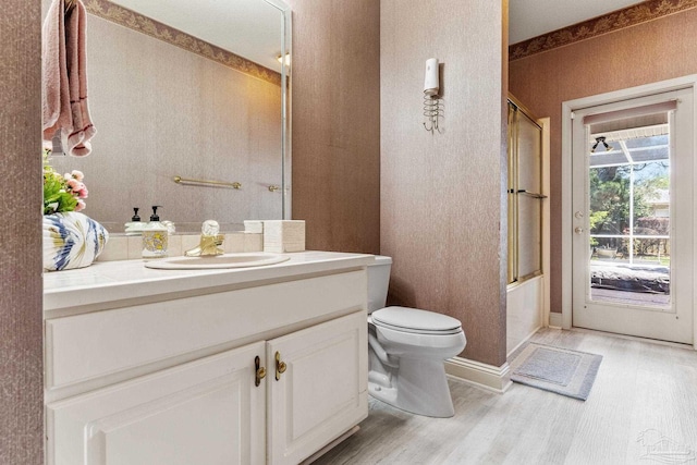 1126 Mary Kate Dr, Gulf Breeze, FL 32563 - full bath with wood finished floors, toilet, vanity, and enclosed tub / shower combo