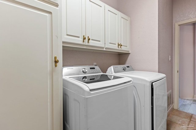 1126 Mary Kate Dr, Gulf Breeze, FL 32563 - laundry room with cabinet space, a textured wall, and washer and dryer