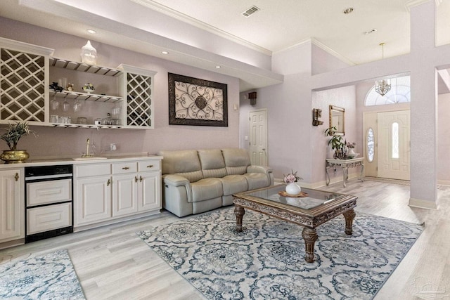 1126 Mary Kate Dr, Gulf Breeze, FL 32563 - living area with light wood finished floors, bar area, visible vents, recessed lighting, and crown molding