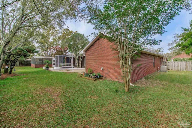 1126 Mary Kate Dr, Gulf Breeze, FL 32563 - view of yard with a fenced backyard, a sunroom, and central air condition unit
