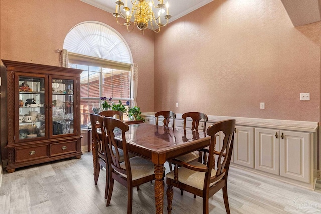 1126 Mary Kate Dr, Gulf Breeze, FL 32563 - dining area featuring light wood-type flooring, a textured wall, a chandelier, and crown molding