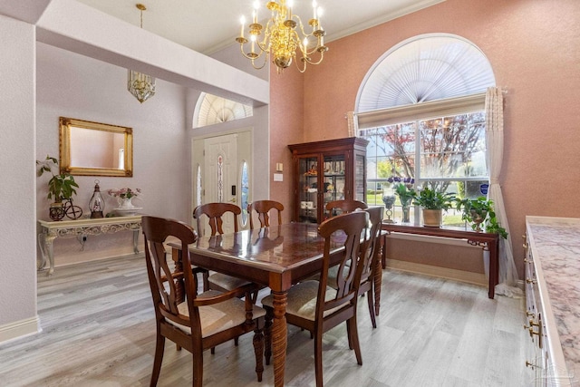 1126 Mary Kate Dr, Gulf Breeze, FL 32563 - dining room with light wood finished floors, baseboards, an inviting chandelier, and crown molding