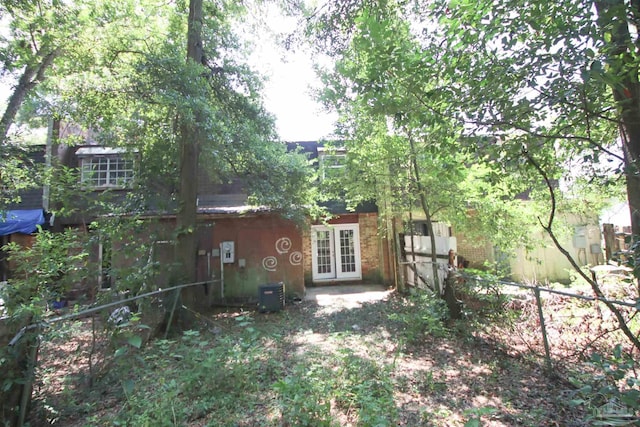 rear view of house with french doors and central AC