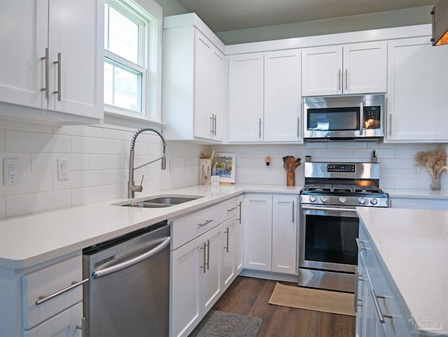817 N D St, Pensacola, FL 32501 - kitchen with stainless steel appliances, white cabinetry, and a sink