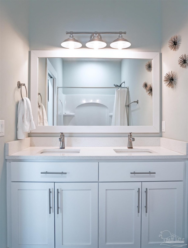 817 N D St, Pensacola, FL 32501 - full bath with a shower with shower curtain, double vanity, and a sink