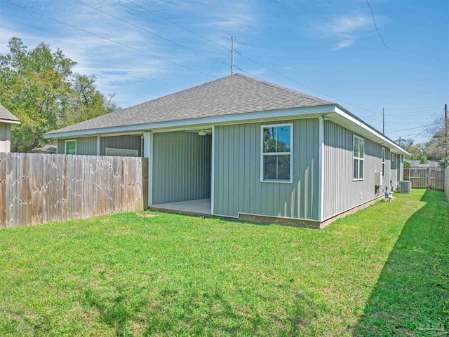 817 N D St, Pensacola, FL 32501 - exterior space featuring a yard, fence, central air condition unit, and roof with shingles