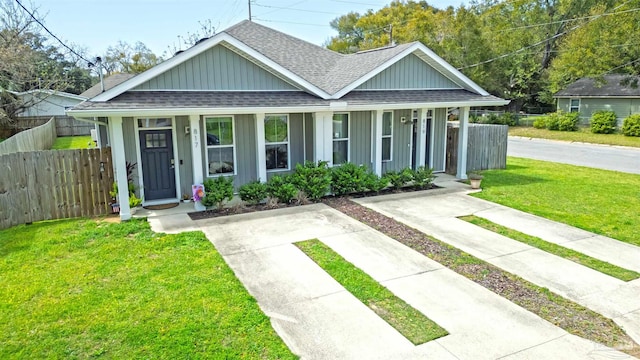 817 N D St, Pensacola, FL 32501 - bungalow with roof with shingles, covered porch, and fence