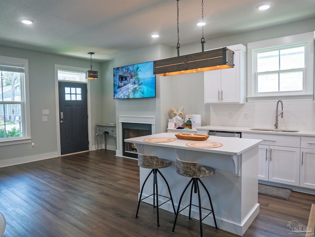 817 N D St, Pensacola, FL 32501 - kitchen featuring a kitchen bar, white cabinetry, recessed lighting, a sink, and light countertops