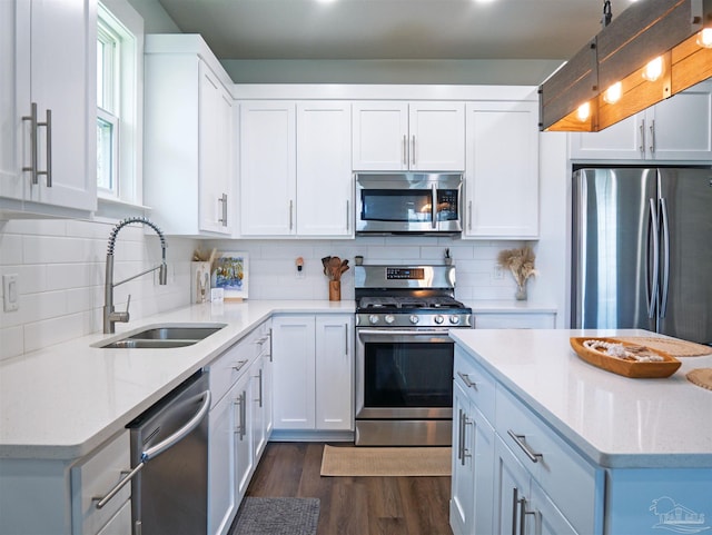 817 N D St, Pensacola, FL 32501 - kitchen featuring tasteful backsplash, white cabinets, dark wood-type flooring, appliances with stainless steel finishes, and a sink