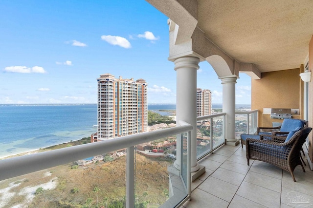 balcony with a water view and a beach view