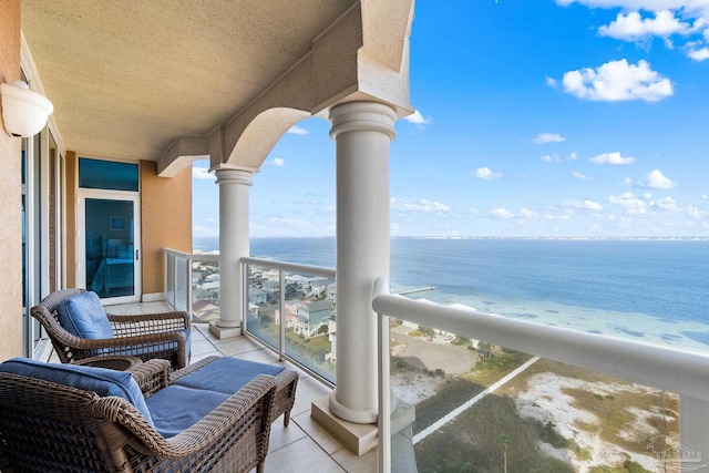 balcony featuring a water view and a beach view