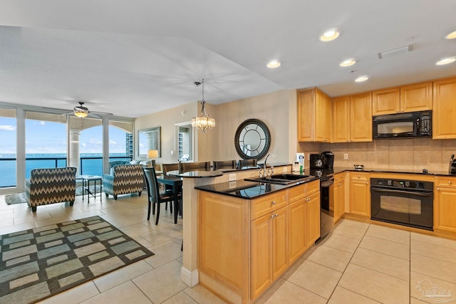 kitchen with a water view, black appliances, sink, and kitchen peninsula