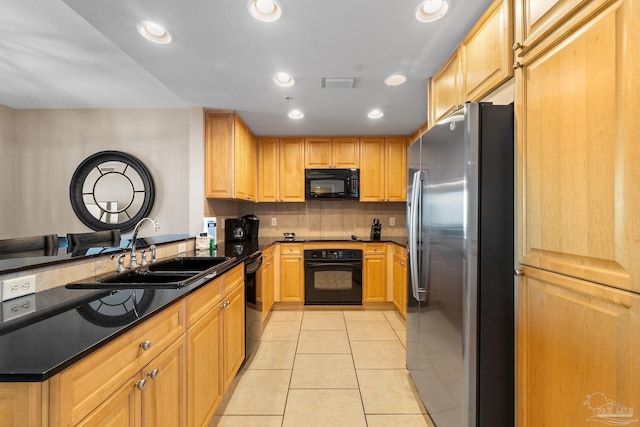 kitchen featuring tasteful backsplash, light tile patterned floors, light brown cabinetry, black appliances, and sink