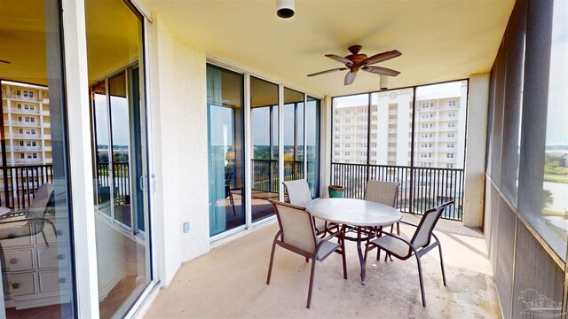 sunroom / solarium featuring ceiling fan