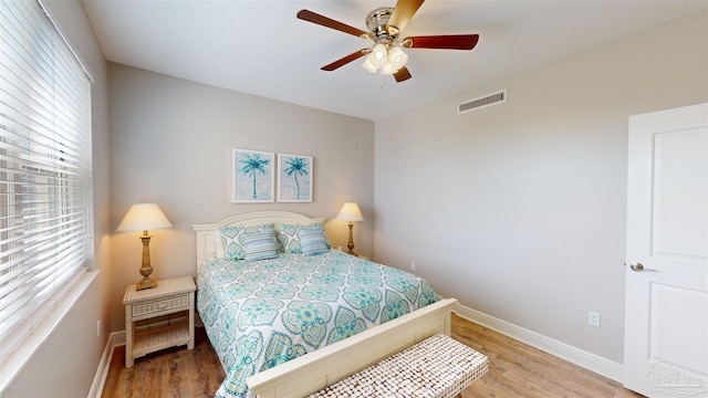 bedroom with light hardwood / wood-style floors and ceiling fan