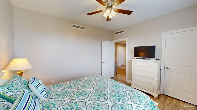 bedroom featuring light wood-type flooring and ceiling fan