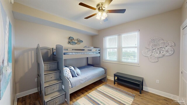 bedroom with ceiling fan and hardwood / wood-style flooring