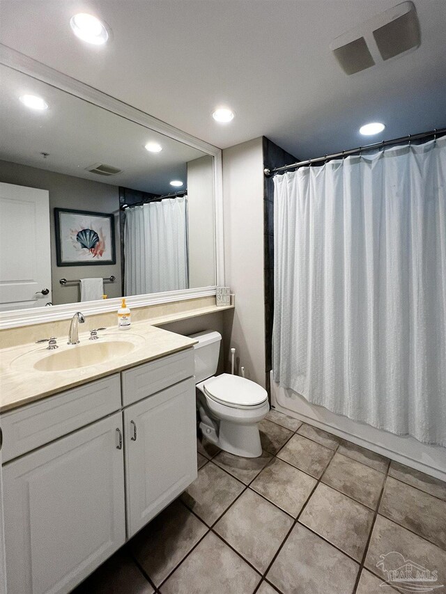 full bathroom with tile patterned flooring, vanity, toilet, and shower / bath combo with shower curtain