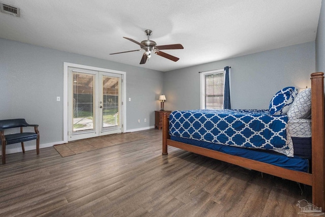 bedroom featuring multiple windows, ceiling fan, dark hardwood / wood-style floors, and access to exterior