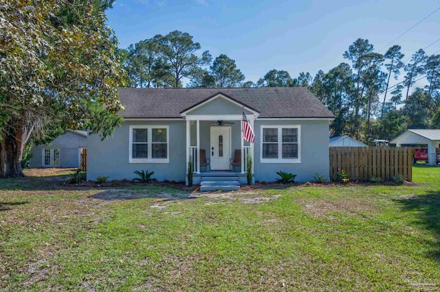 bungalow-style home with a front yard