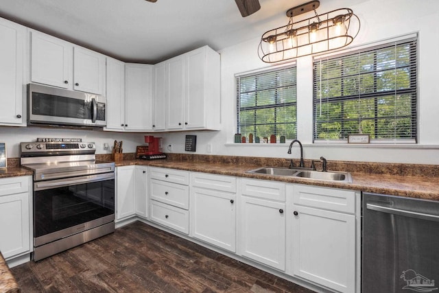 kitchen featuring white cabinetry, dark hardwood / wood-style flooring, sink, and stainless steel appliances