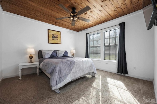 carpeted bedroom with wood ceiling and ceiling fan