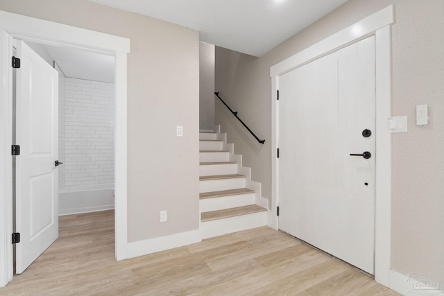 entryway with light hardwood / wood-style floors