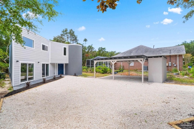 back of house featuring a carport