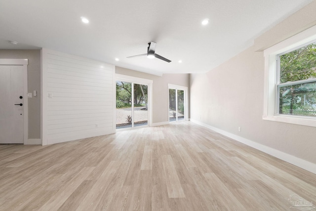 unfurnished living room with light hardwood / wood-style flooring and ceiling fan