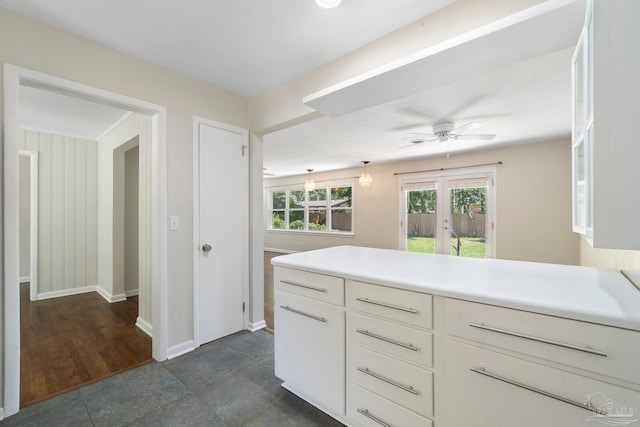 770 Connell Dr, Pensacola, FL 32503 - kitchen featuring ceiling fan, light countertops, baseboards, white cabinets, and a peninsula