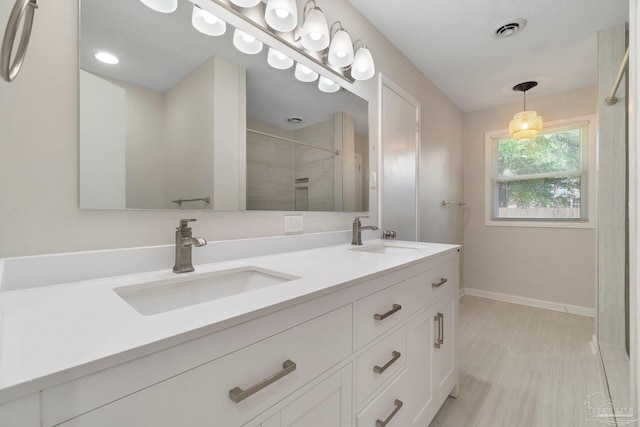 770 Connell Dr, Pensacola, FL 32503 - bathroom featuring baseboards, a stall shower, and double vanity
