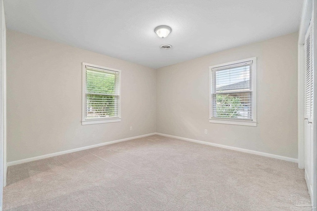 770 Connell Dr, Pensacola, FL 32503 - unfurnished bedroom with multiple windows, carpet flooring, and baseboards