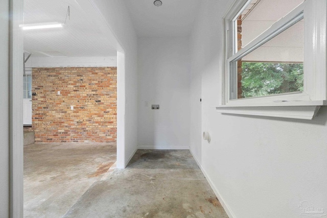 770 Connell Dr, Pensacola, FL 32503 - hall featuring unfinished concrete flooring, brick wall, and baseboards