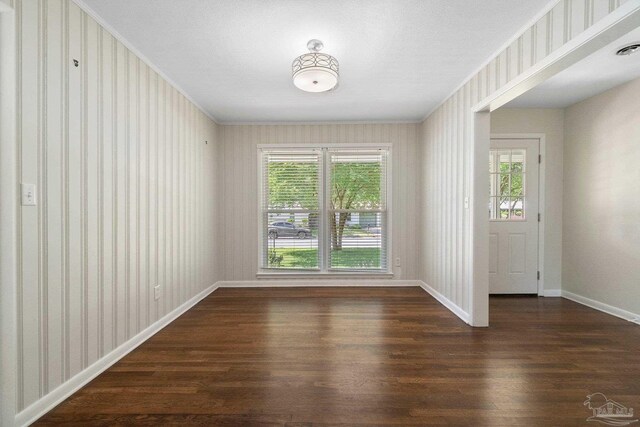 770 Connell Dr, Pensacola, FL 32503 - unfurnished dining area with ornamental molding, wood finished floors, baseboards, and wallpapered walls