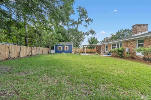 770 Connell Dr, Pensacola, FL 32503 - view of yard with an outdoor structure, a storage shed, and a patio area