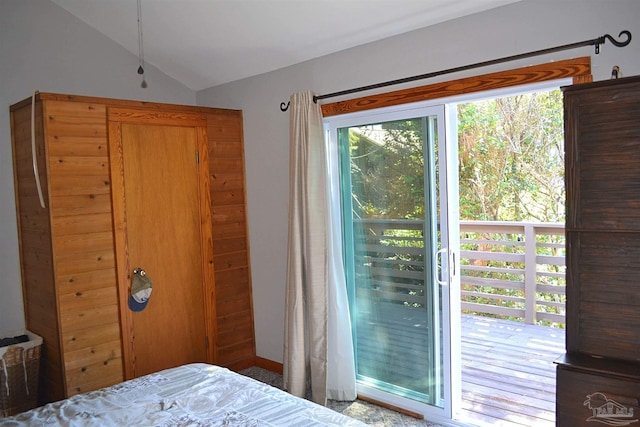 bedroom featuring access to exterior and lofted ceiling