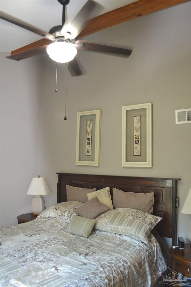 bedroom with ceiling fan and beamed ceiling