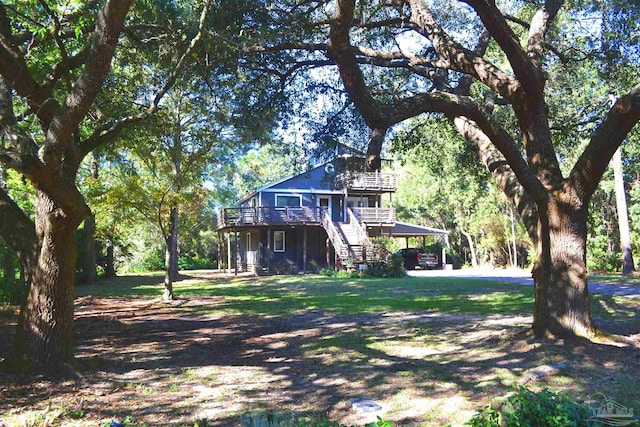 view of yard featuring a carport and a wooden deck