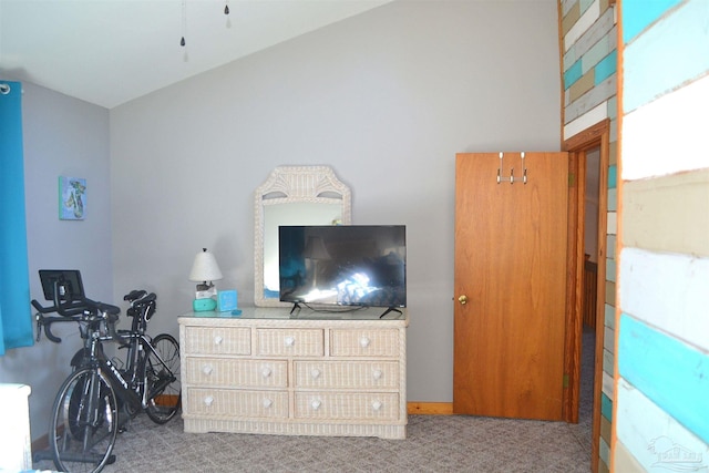 bedroom featuring light colored carpet and lofted ceiling