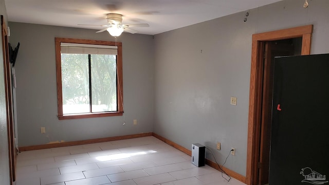 unfurnished room with light tile patterned floors and ceiling fan