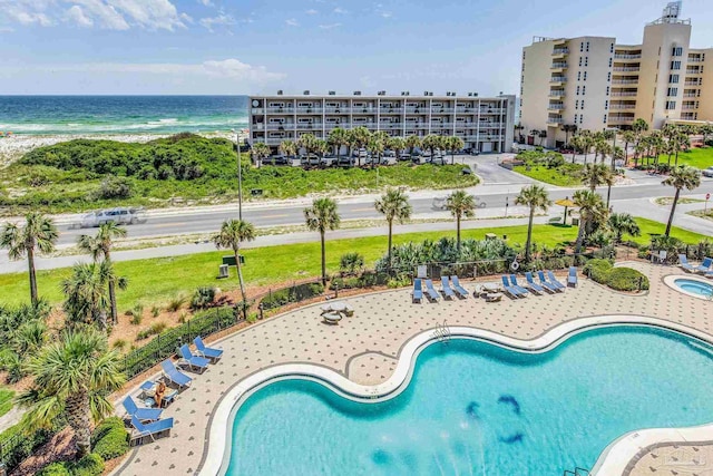 view of swimming pool featuring a water view and a patio area