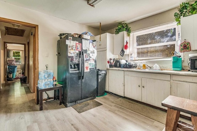 kitchen featuring light hardwood / wood-style floors, sink, and fridge with ice dispenser