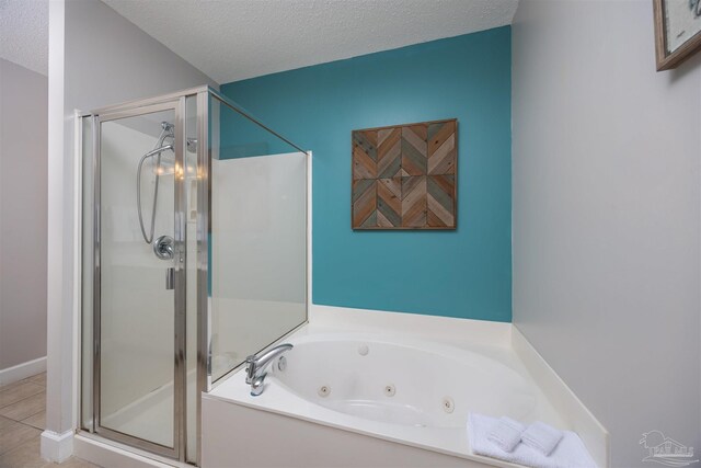 bathroom with tile patterned floors, plus walk in shower, and a textured ceiling