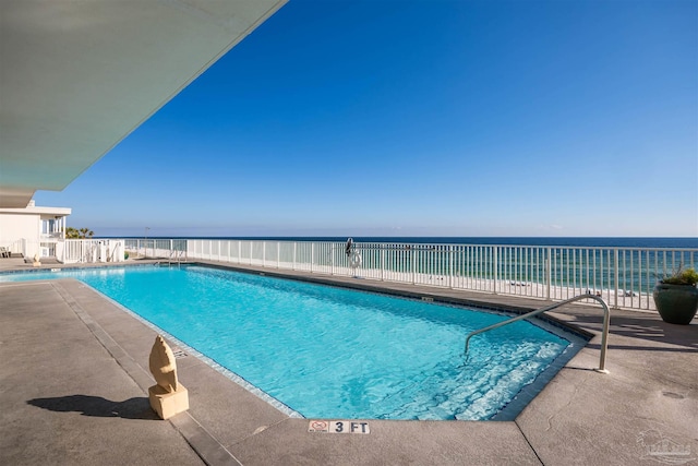 view of swimming pool with a water view and a patio area